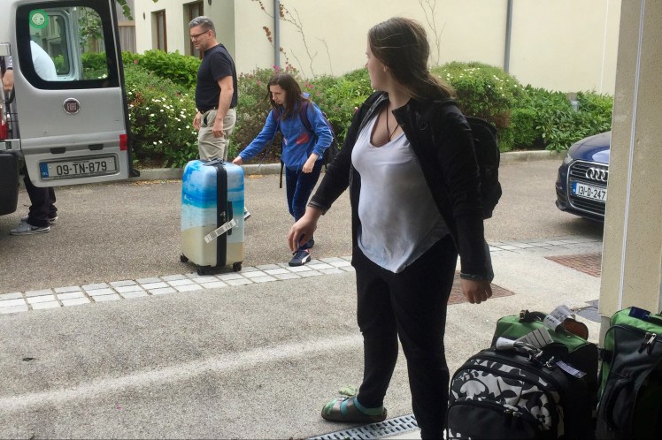 Family unloading the van from the airport.